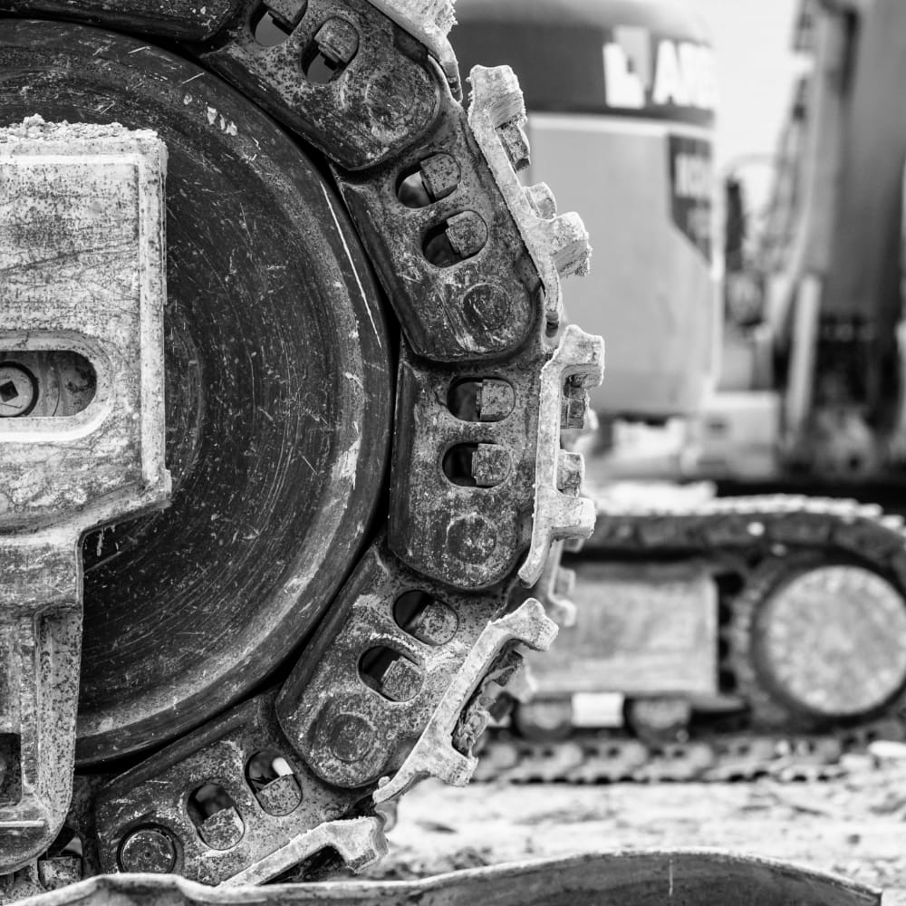 A close up on the track of heavy earthmoving equipment.
